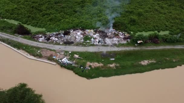 Aerial Pull Back Illegal Burning Rubbish Dump Site — Stockvideo