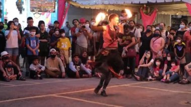 Butterworth, Penang, Malaysia - Dec 10 2022: Follow focus a woman perform fire show at outdoor street