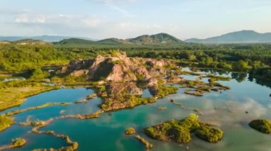 Drone shoot hyperlapse over green blue natural quarry Guar Petai, Penang, Malaysia in gentle day