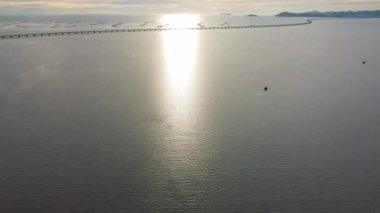 Drone hyperlapse move forward to Penang Second Bridge in evening hour from mangrove forest at coastal
