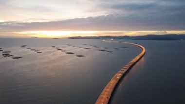 Drone shot establish Penang Second Bridge in dusk hour. Aerial car traffic at highway