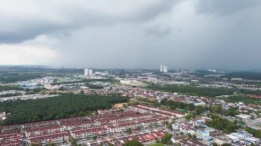 Drone shot hyperlapse move toward raining dark cloud at rural residential town at Bukit Mertaiam, Malaysia