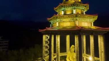 Sungai Nibong, Penang, Malaysia - Feb 14 2022: Hyperlapse night scene of illuminated Goddess of Mercy at Pavilion, Kek Lok Si temple