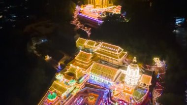 Georgetown, Penang, Malaysia - Feb 14 2022: Drone hyperlapse spectacular night view of illumination from pagoda to Goddess of Mercy Pavilion