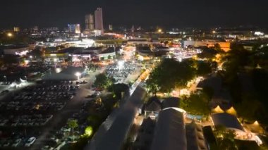 Sungai Nibong, Penang, Malaysia - Oct 07 2022: Drone shot hyperlapse people attend to car show Auto City Carnival in night