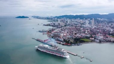 Bayan Lepas, Penang, Malaysia - Oct 25 2022: Drone shot hyperlapse move forward Georgetown Penang Cruise Port. Genting Dream Cruise disembark from jetty