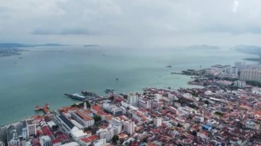 Sungai Nibong, Penang, Malaysia - Nov 01 2022: Drone shot hyperlapse move forward to the sea near clan jetty, Penang during raining day