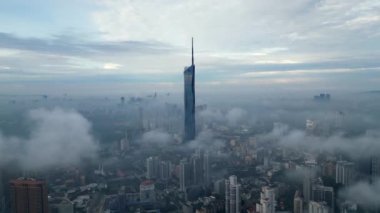 Bukit Bintang, Kuala Lumpur, Malaysia - Nov 13 2022: Aerial move toward PNB118, Warisan Merdeka 118, KL 118 Tower and KL 118 in fog cloud morning