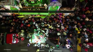 Georgetown, Penang, Malaysia - Jan 04 2023: Aerial top down view Hindu priest strew flower at statue on chariot at street