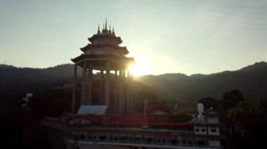 Ayer Itam, Penang, Malaysia - Jan 15 2023: Aerial fly forward Pavilion in evening sun light silhouette