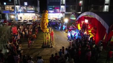 Seberang Perai, Penang, Malaysia - Jan 27 2023: Aerial view lion dance perform on high poles in night