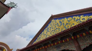 Ayer Itam, Penang, Malaysia - Feb 04 2024: A smooth pan reveals the intricate roof design at Kek Lok Si Temple.