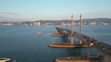 Gelugor, Penang, Malaysia - Feb 28 2024: Penang Bridge over sea with construction of monopole transmission tower
