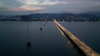 Gelugor, Penang, Malaysia - Apr 16 2024: Blue and orange hues embrace the Penang Bridge in the early evening.