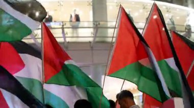 Bukit Bintang, Kuala Lumpur, Malaysia - Oct 26 2024: The night parade lights up with voices chanting for justice and waving Palestine flags.
