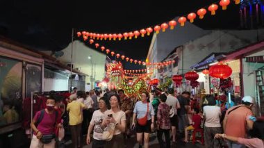 George Town, Penang, Malaysia - Jan 27 2024: A group of people are performing a dragon dance at street during Kwong Wah Yit Poh Chinese New Year Gala