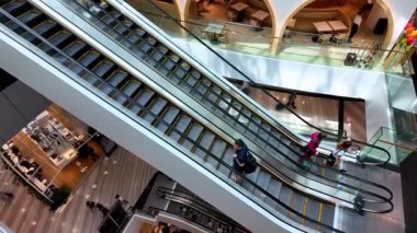 Changi, Singapore - Jul 16 2024: People are riding an escalator in a mall at Changi Airport