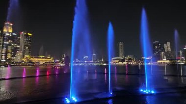 Marina Sand, Singapore - Jul 17 2024: Nighttime drone footage capturing the full spectacle of Spectra - A Light and Water Show.