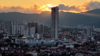 George Town, Penang, Malaysia - Nov 03 2024: Drone view circles the towering KOMTAR building at dusk.