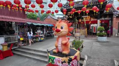 Bayan Lepas, Penang, Malaysia - Feb 14 2024: A dragon statue is in the middle of a courtyard at snake temple