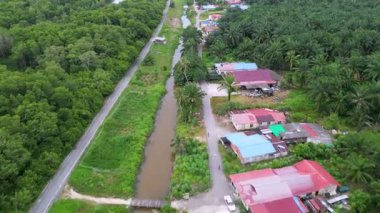 Batu Pahat, Johor, Malaysia - May 31 2024: A road with a river running alongside it
