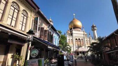 Kampung Glam, Singapore - Jul 11 2024: A street with building Sultan Mosque in blue sunny day