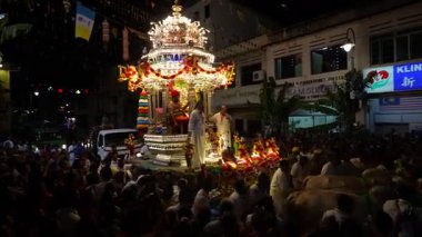 George Town, Penang, Malaysia - Jan 24 2024: Thaipusam chariot procession through the streets with devotees.