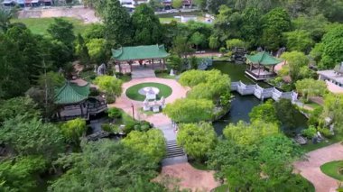 Yong Peng, Johor, Malaysia - May 30 2024: Aerial view circling the majestic Fortune Dragon Temple