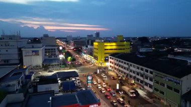 Batu Pahat, Johor, Malaysia - May 31 2024: A town street with a yellow building in the background. There are cars on the street