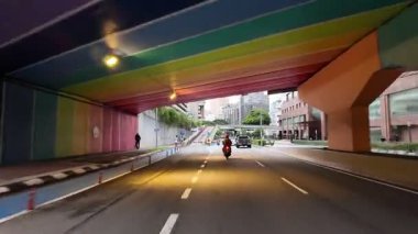Bukit Bintang, Kuala Lumpur, Malaysia - Jun 15 2024: A man on a motorcycle is riding down a street.