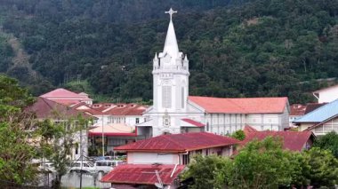 Balik Pulau, Penang, Malaysia - Nov 25 2024: Small town with a church and a hill in the background