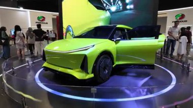 Segambut, Kuala Lumpur, Malaysia - Dec 07 2024: The exhibition hall Green Perodua EV EMO-II car buzzes with visitors engaging with futuristic mobility at KLIMS