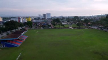 Batu Pahat, Johor, Malaysia - Jun 03 2024: A soccer field with a blue and red bleacher at Stadium Batu pahat