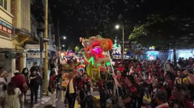 George Town, Penang, Malaysia - Feb 24 2024: People of all ages gather to enjoy the grand dragon with bubbles during Poh Hock Seah Grand Float Procession