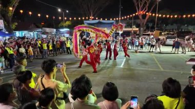 Bayan Lepas, Penang, Malaysia - Feb 14 2024: A group of people are watching a performance dragon dance at snake temple