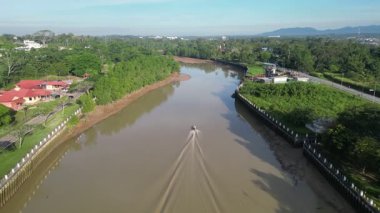 Kota Tinggi, Johor, Malaysia - Apr 29 2024: A boat is traveling down Sungai Johor. The water is brown and murky