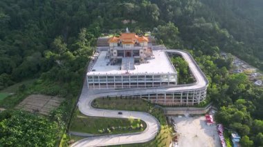 Batu Pahat, Johor, Malaysia - May 30 2024: A bird eye aerial of a traditional Chinese temple perched amidst lush greenery and open sky.