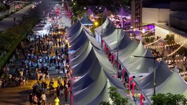 Batu Kawan, Penang, Malaysia - Nov 10 2024: Aerial capture of bustling street food stalls and moving crowd at Design Village
