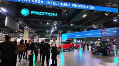 Segambut, Kuala Lumpur, Malaysia - Dec 07 2024: Large group of people are gathered around a display of a Proton car X50 during Kuala Lumpur International Mobility Show (KLIMS)