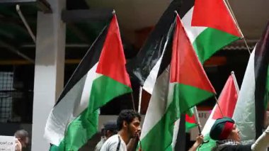 Bukit Bintang, Kuala Lumpur, Malaysia - Oct 26 2024: Wrapped in the colors of Palestine, marchers step forward for freedom and dignity.