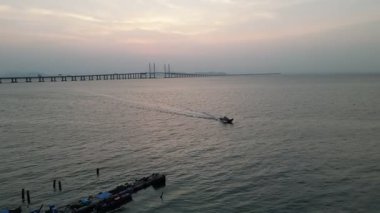 Batu Maung, Penang, Malaysia - Mar 20 2024: Scenic aerial perspective showing Batu Maung wooden jetties stretching into the sea.