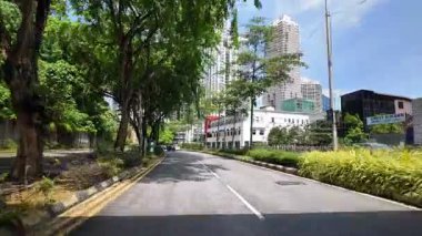 Bukit Bintang, Kuala Lumpur, Malaysia - Jun 15 2024: A road with a bridge over it and a town in the background