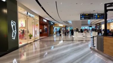Changi, Singapore - Jul 16 2024: There are people walking around and shopping in Changi Airport