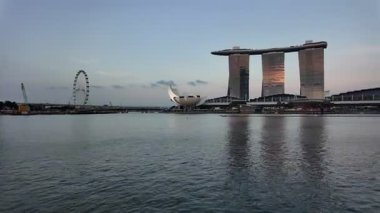 Marina Sand, Singapore - Jul 17 2024: Pan right Marina Bay Sand. There is a large Singapore Flyer in the background