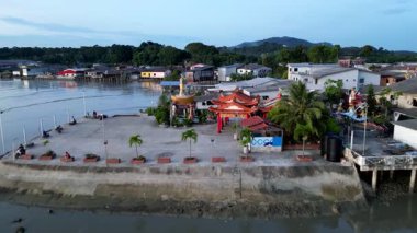 Batu Pahat, Johor, Malaysia - May 30 2024: A river with a town on the bank Segenting. The water is brown and murky