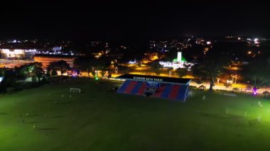 Batu Pahat, Johor, Malaysia - May 29 2024: A soccer field with a stadium Batu Pahat in the background.