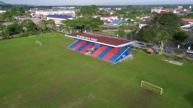 Batu Pahat, Johor, Malaysia - Jun 03 2024: A soccer field with a stadium in the background. The stadium is empty.