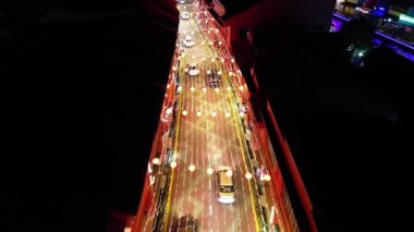 Bandar Hilir, Melaka, Malaysia - Mar 04 2024: Aerial car traffic lights forming glowing trails.