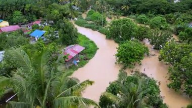 Machang Bubuk, Penang, Malaysia - Sep 17 2024: Widespread flooding houses and roads in rural Malaysian landscape.