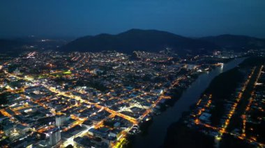 Batu Pahat, Johor, Malaysia - May 31 2024: A town at night with a river running through it. The town is lit up with lights